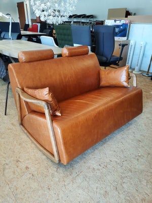 Stilfuld 2 personers lædersofa med vip-/gyngefunktion